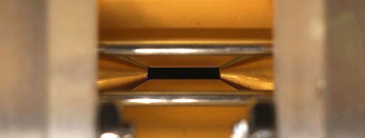 Strontium ions (blue) confined in a Paul trap