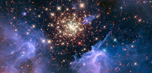 A dense cluster of hot stars with whisps of gas around it.
